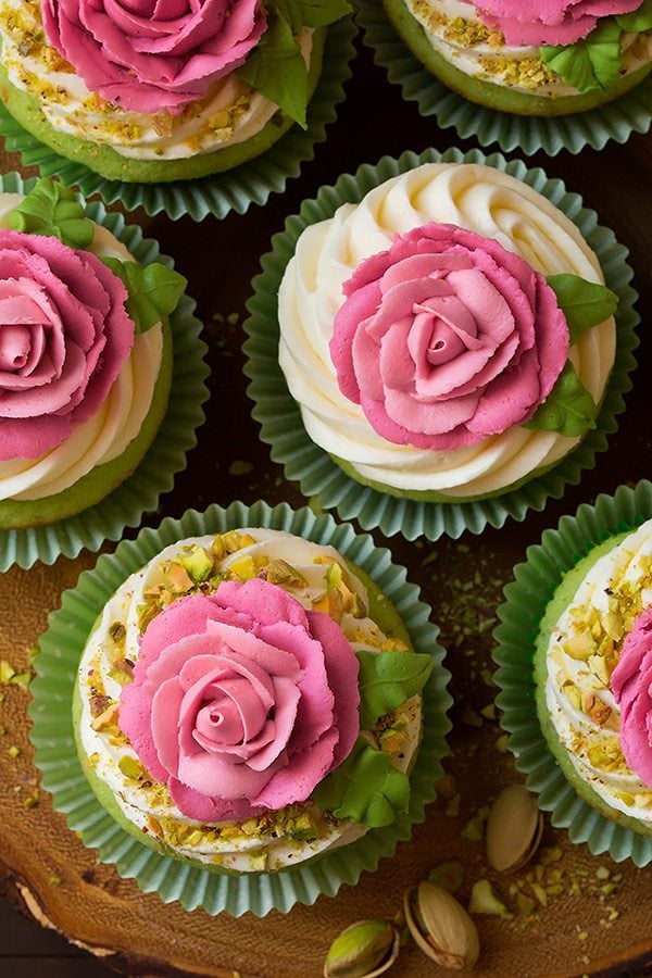 Pistachio Cupcakes Pistachio cupcakes with pink piped buttercream roses on top.