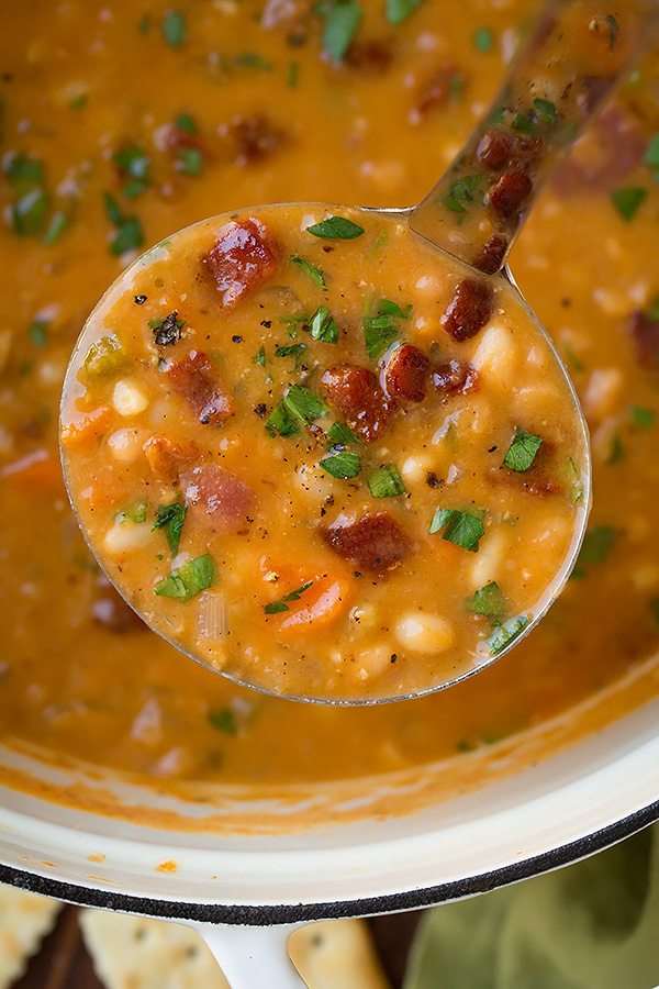Bean and Bacon Soup Close up image of a ladle filled with bean and bacon soup.