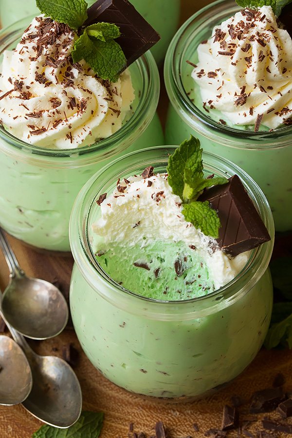 Mint Chip Cheesecake Mousse Mint chip cheesecake mousse in a glass jar with a scoop removed to show texture.
