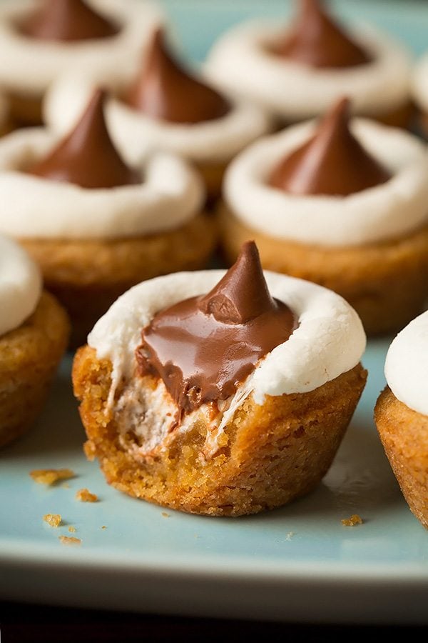 Mini S'mores Cookie Cups S'more cookie with a bite taken out to show gooey melted chocolate center.