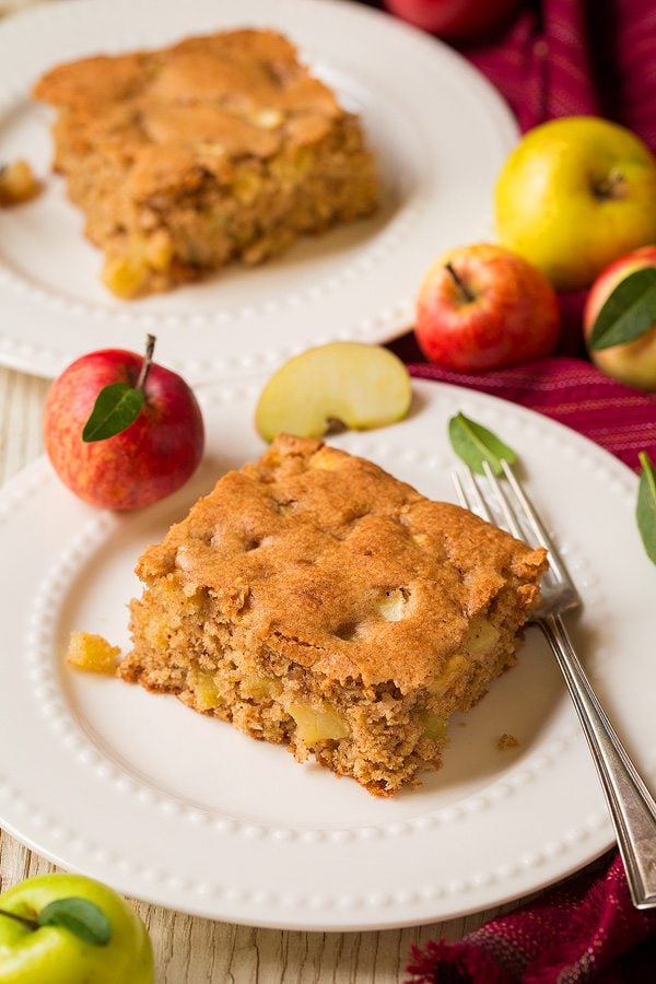 Warm Apple Cake Two slices of apple cake on dessert plates.
