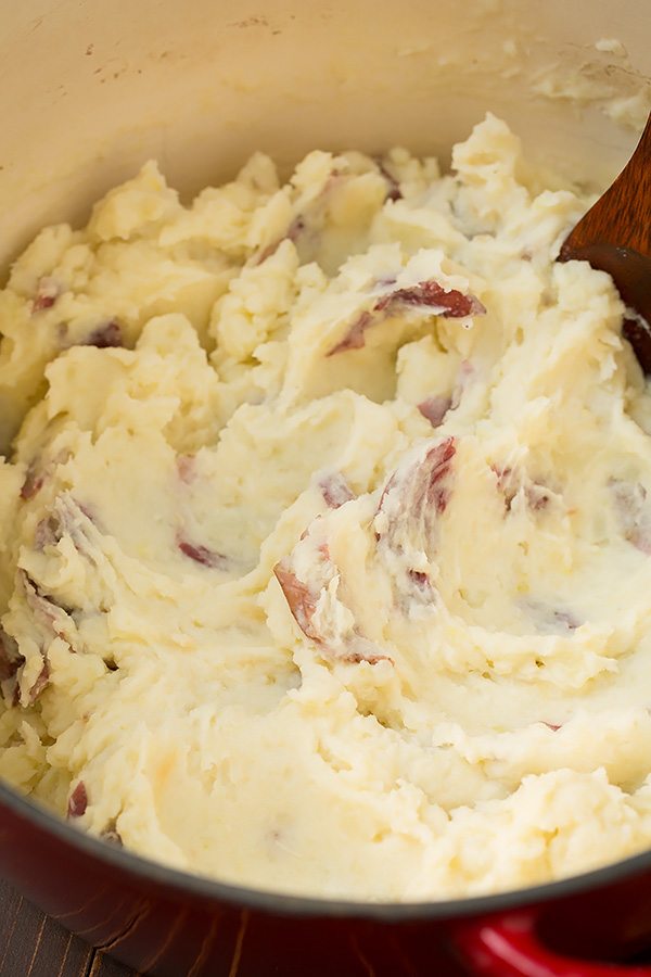 Roasted Garlic Mashed Potatoes Red potatoes after being mashed in a pot.