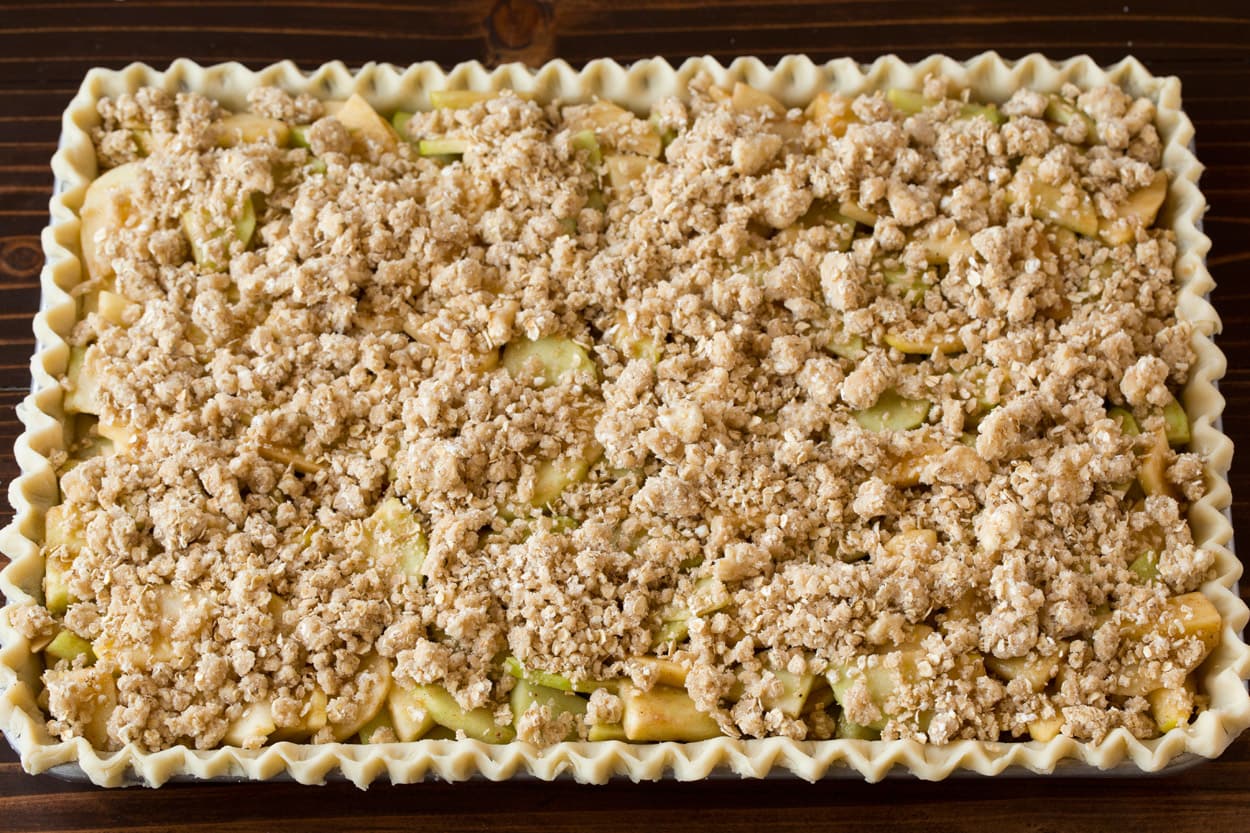 Apple Slab Pie Crumb topping added to apple slab pie.