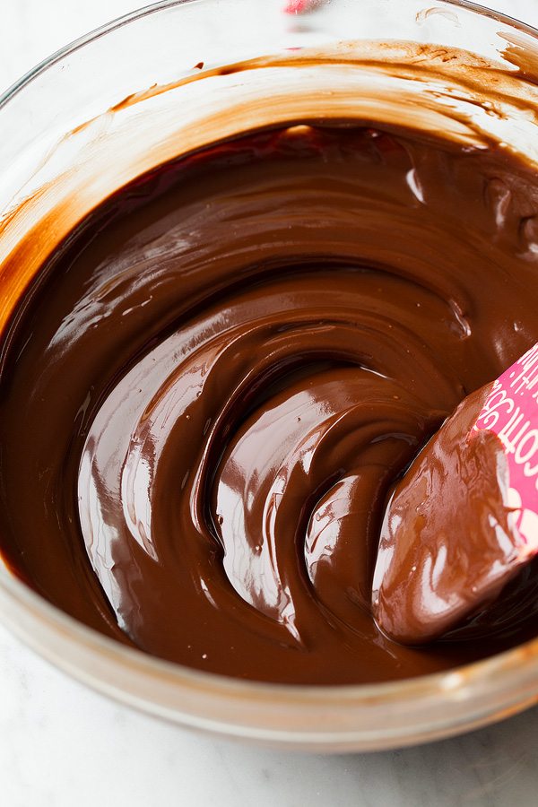 Peppermint Hot Chocolate Cookies Melted chocolate in a glass mixing bowl for hot chocolate cookies.