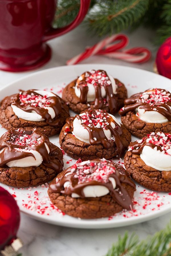 Peppermint Hot Chocolate Cookies Peppermint Hot Chocolate Cookies on a white serving plate with a red mug in the background.