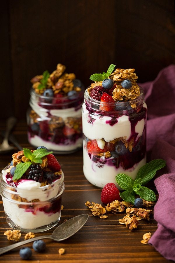Honey Almond Granola Granola yogurt and berry parfaits in glasses.