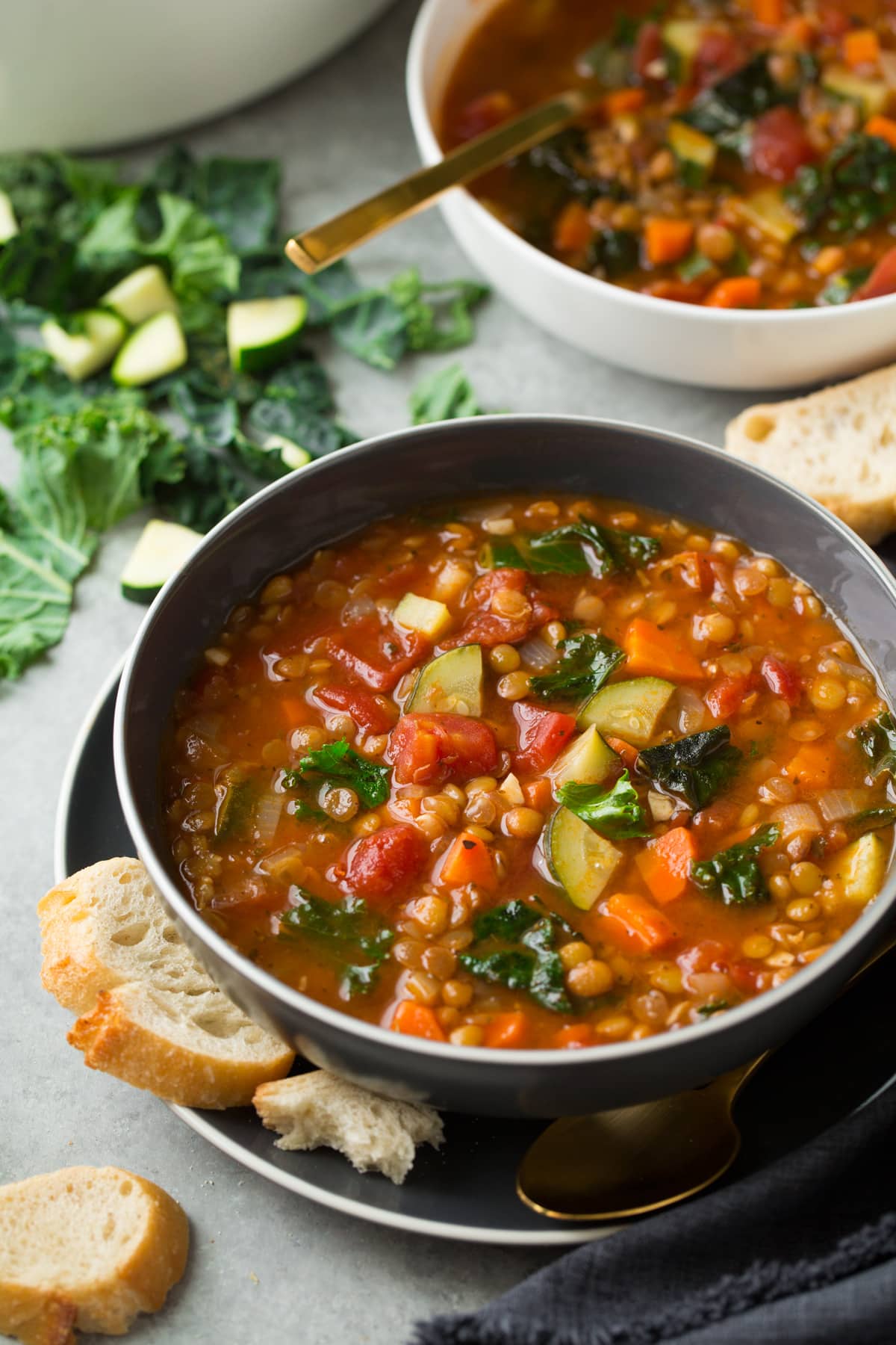 Lentil Soup Lentil Soup in a gray bowl with bread on the side