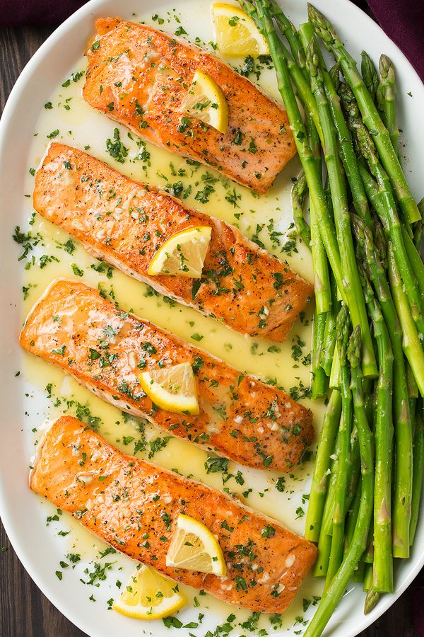 Skillet Seared Salmon with Garlic Lemon Butter Sauce. A delicious and easy meal that's perfect for weeknights. | Salmon Recipes | Fish Recipes | Weeknight Meals | #salmon #fish #cookingclassy Overhead image of four cooked salmon fillets on a serving platter.