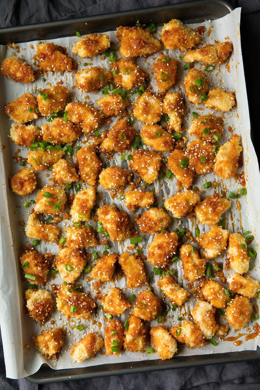 Honey Garlic Chicken Honey Garlic Chicken on a parchment line baking sheet after baking.