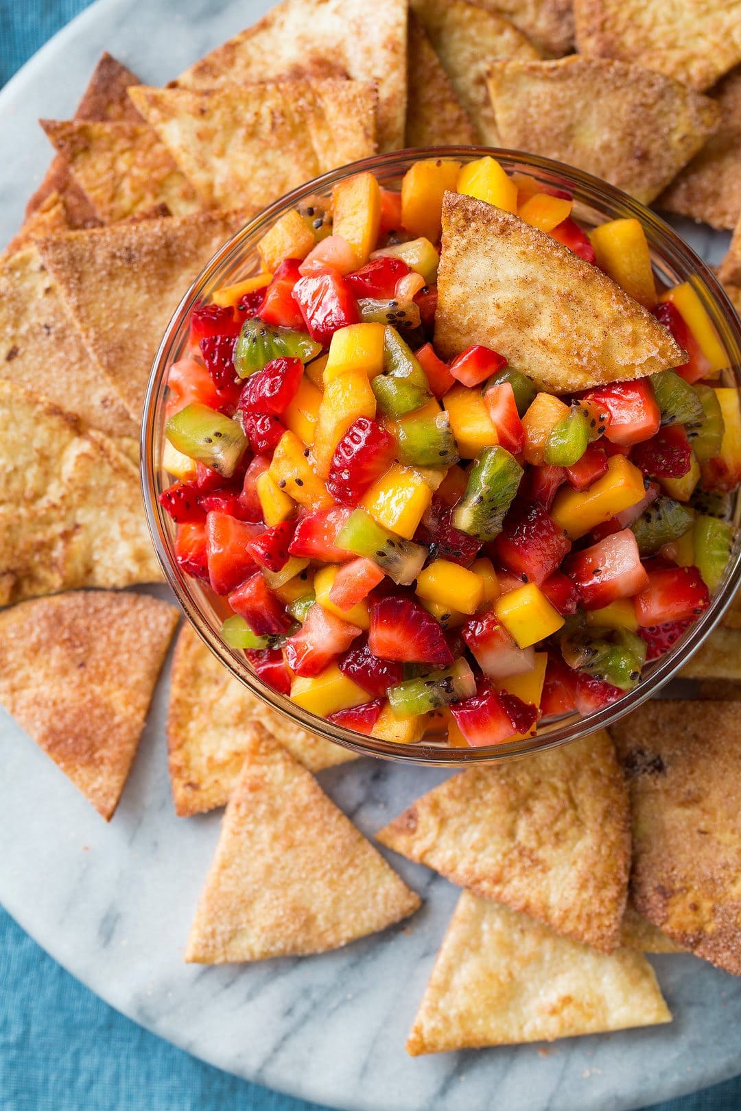 bowl of fresh fruit salsa on plate with cinnamon chips