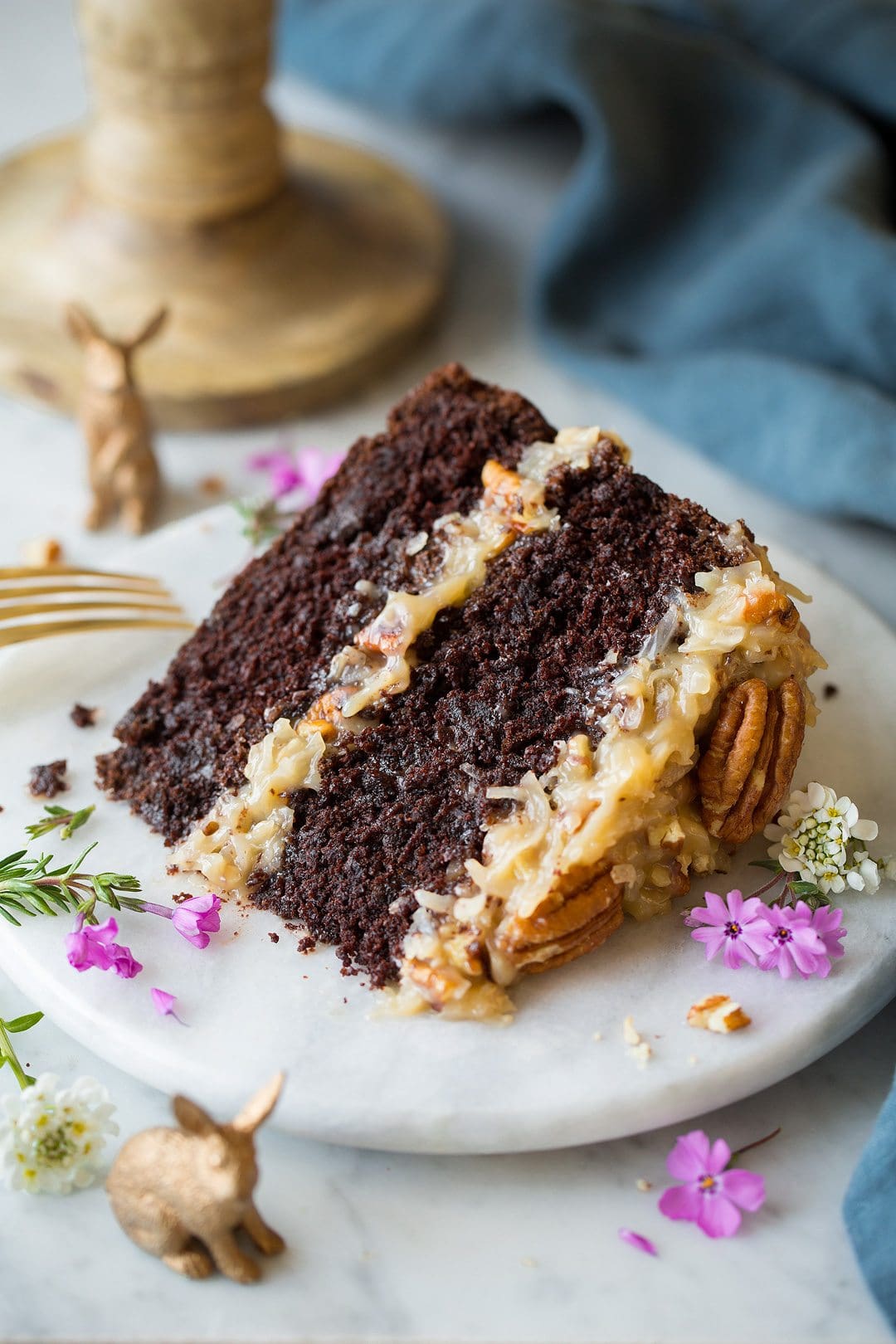 German Chocolate Cake Slice of German Chocolate Cake on a marble plate set over a marble surface.