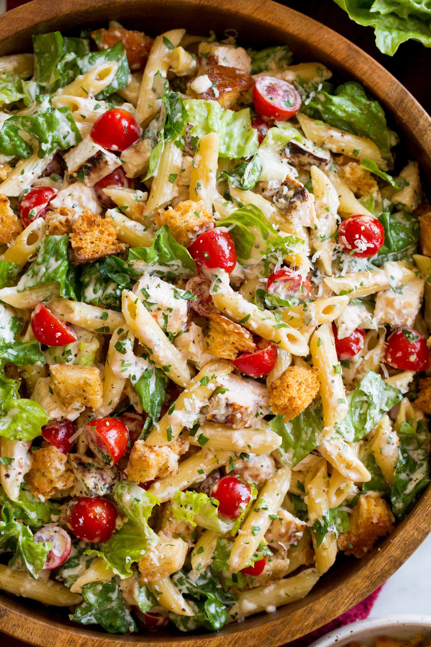 Chicken Caesar Pasta Salad Caesar pasta salad shown close to show various ingredients and textures.