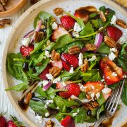 Strawberry Spinach Salad on a plate with balsamic vinegar