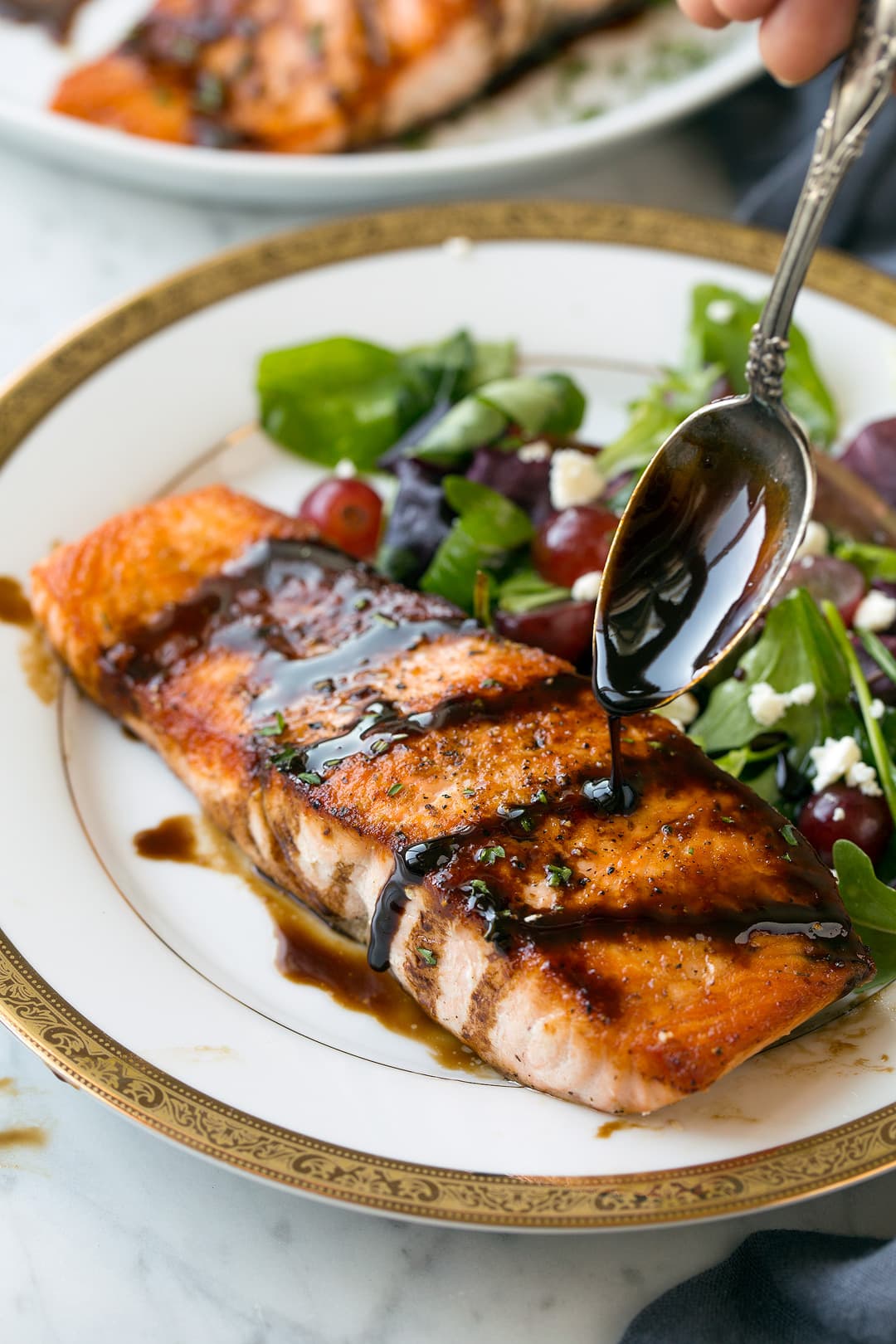 drizzling honey balsamic glaze onto salmon fillet