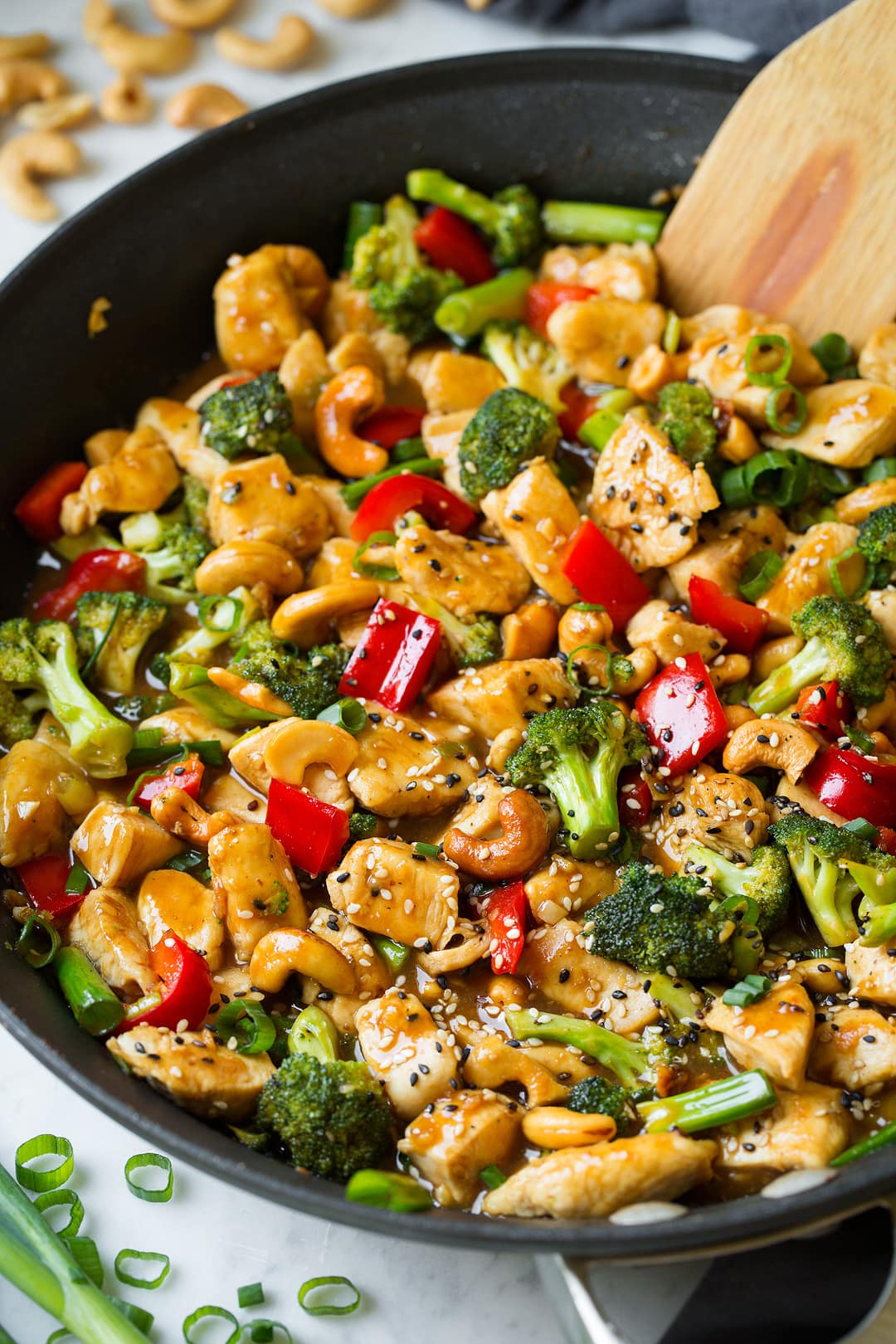 Cashew Chicken shown here in skillet. Includes chicken breasts pieces, broccoli, bell peppers and a sweet and tangy sauce.