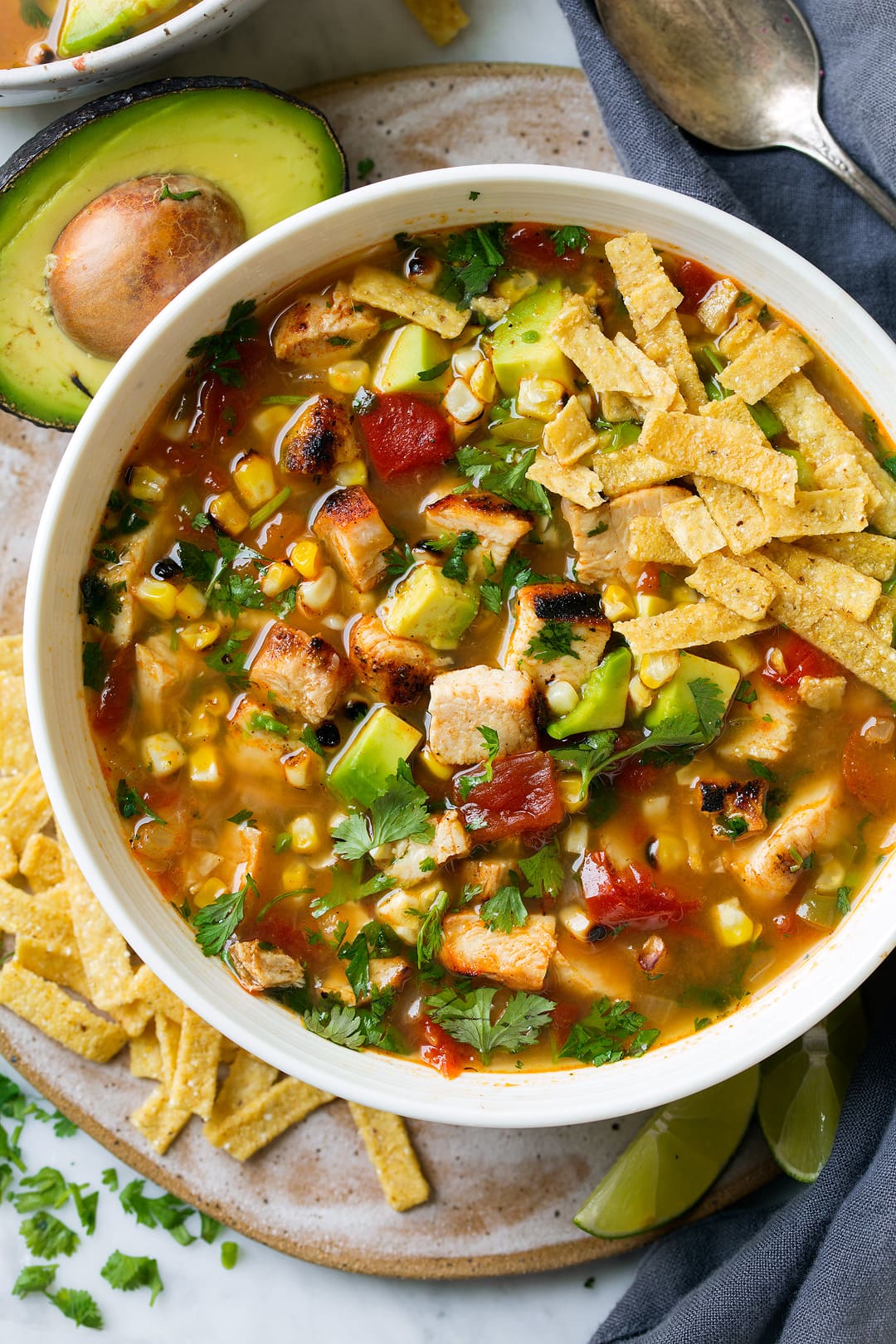 A close up of Grilled Chicken Tortilla Soup in a white bowl
