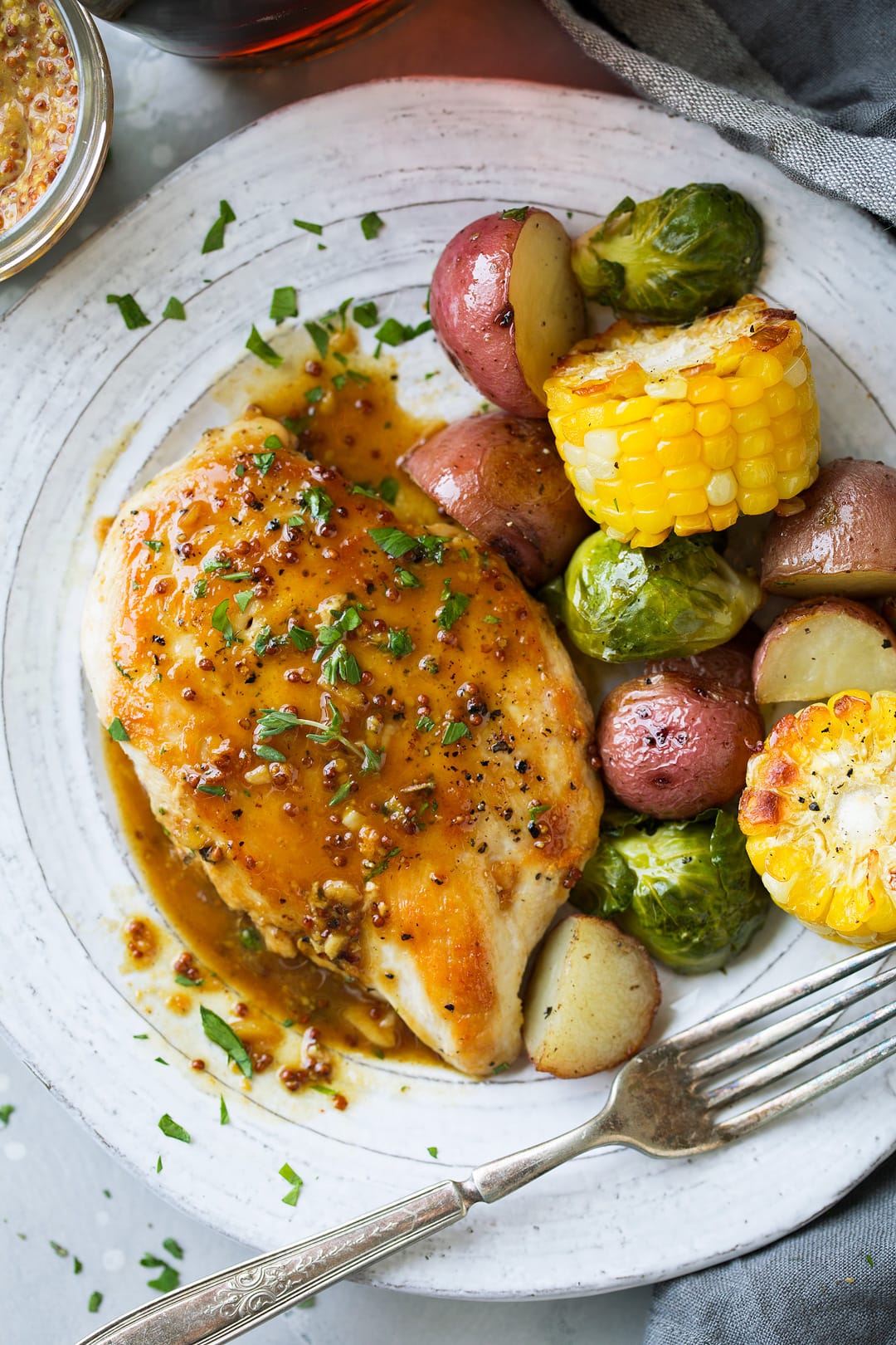 Maple Mustard Skillet Chicken single serving on plate with a side of vegetables.