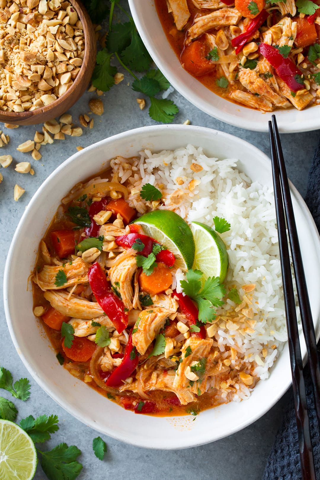 Thai Chicken Curry. A delicious and satisfying Thai chicken curry made in the slow cooker. There's minimal effort required to make this chicken curry and maximum flavor! Serve with rice. | Easy Chicken Curry | Slow Cooker Curry | #cookingclassy #curry #Thaifood #chicken An overhead shot of Slow Cooker Thai Chicken Curry in a white bowl topped with lime wedges
