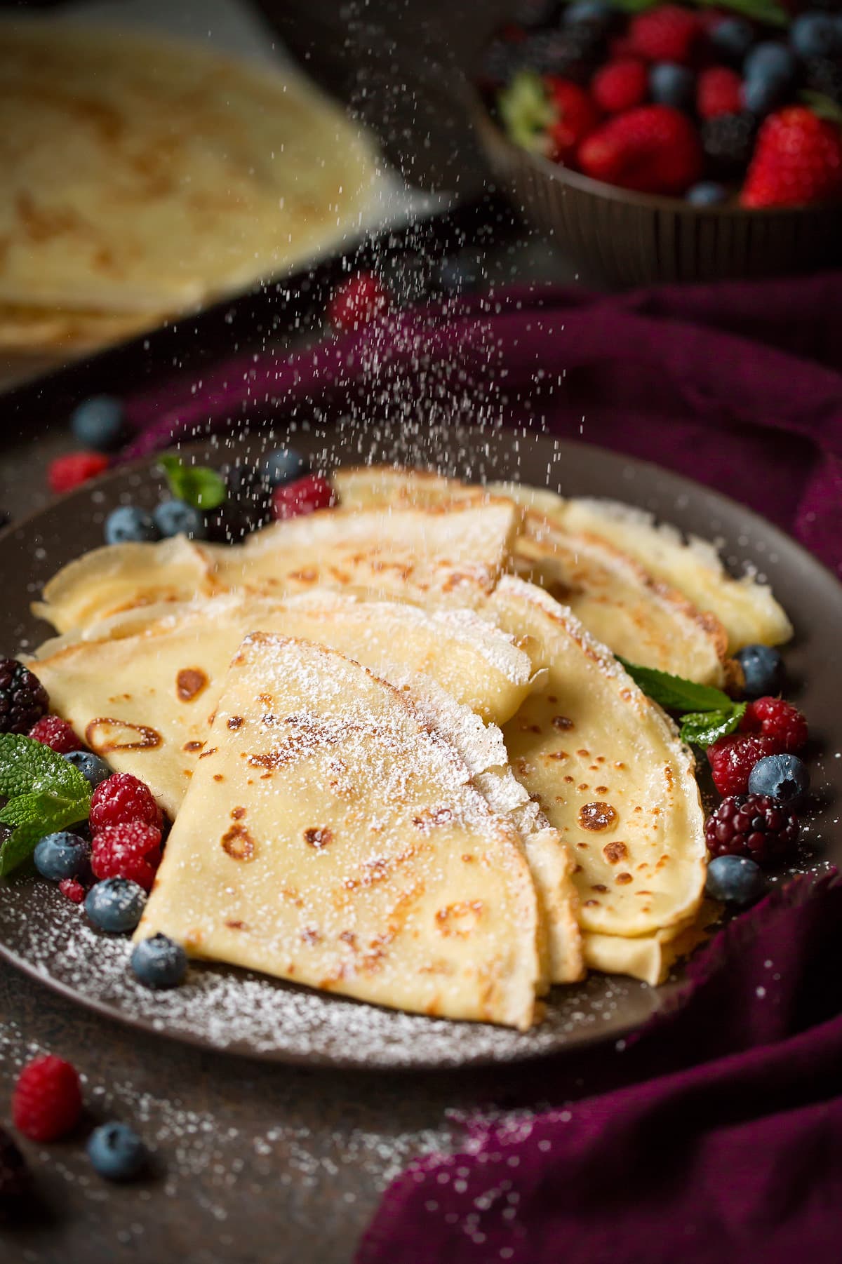 Crepes Recipe Dusting the best crepes, made from scratch with powdered sugar.