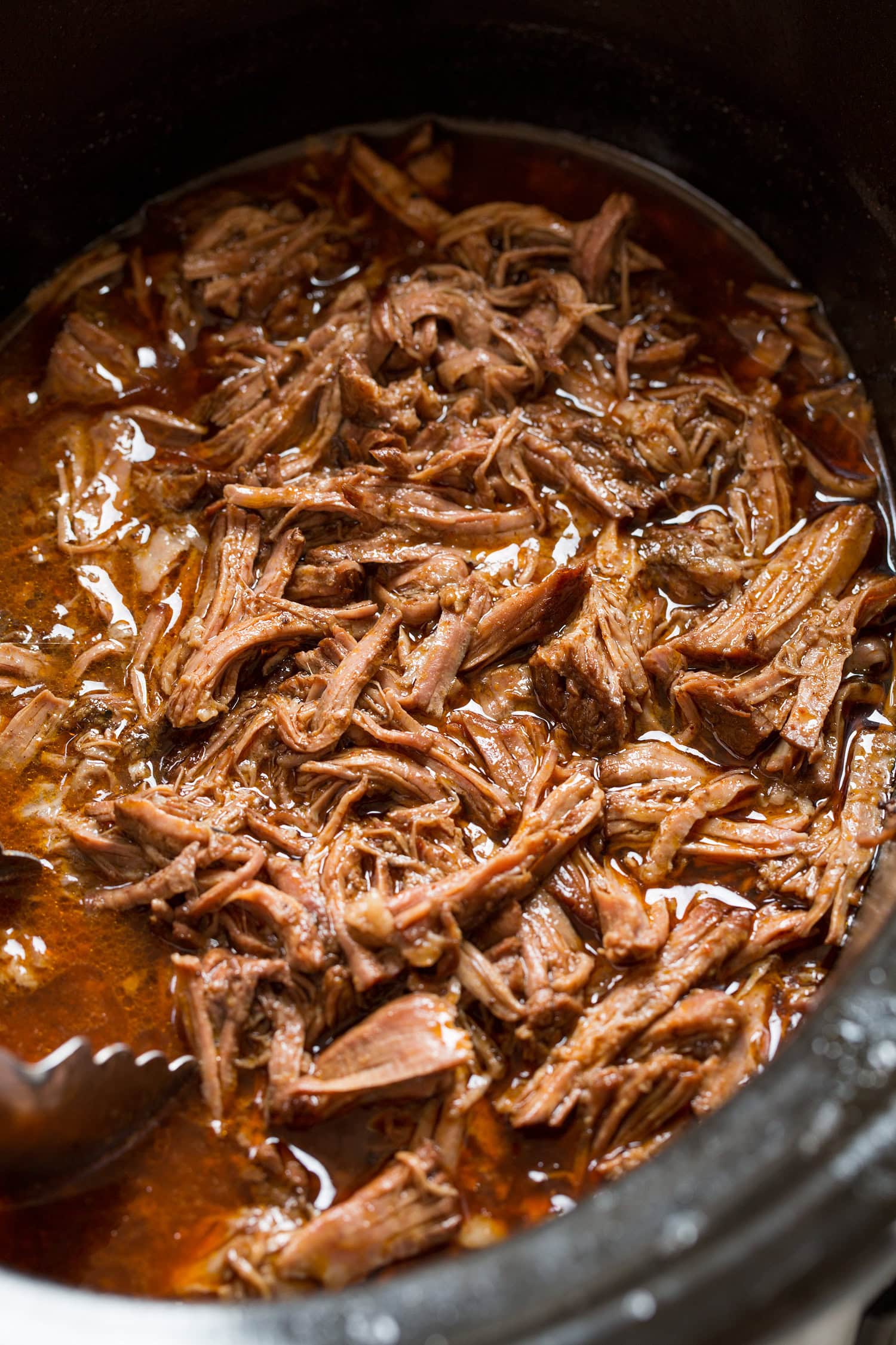 Shredded Beef Tacos Shredded beef in seasoned broth in the slow cooker.