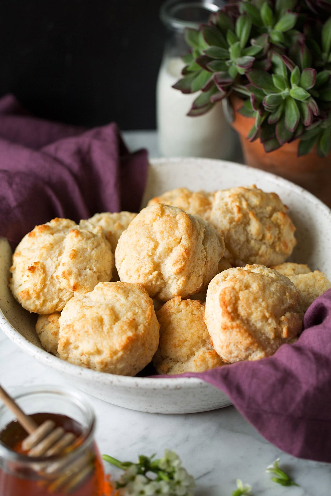 Buttermilk Drop Biscuits in a white bowl with a purple towel