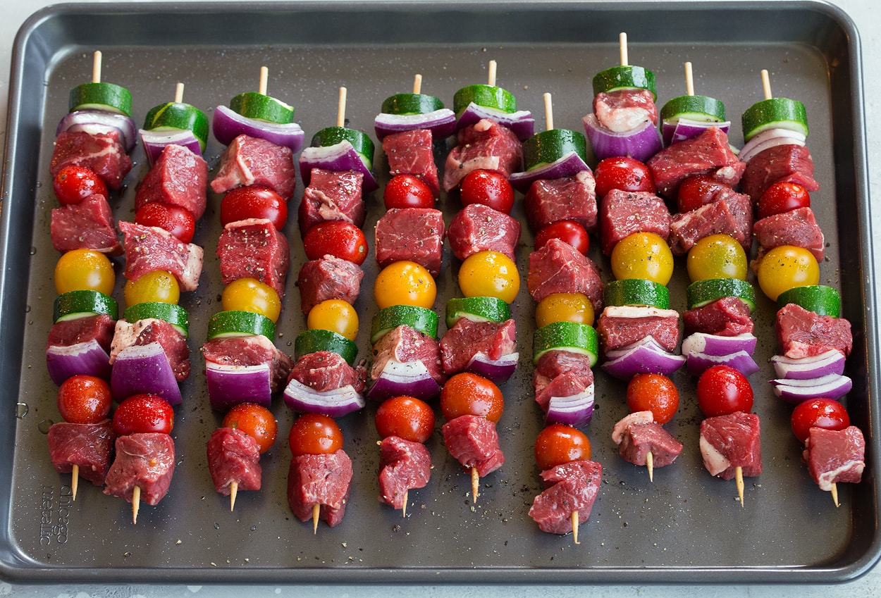 steak tomatoes zucchini on skewers before grilling