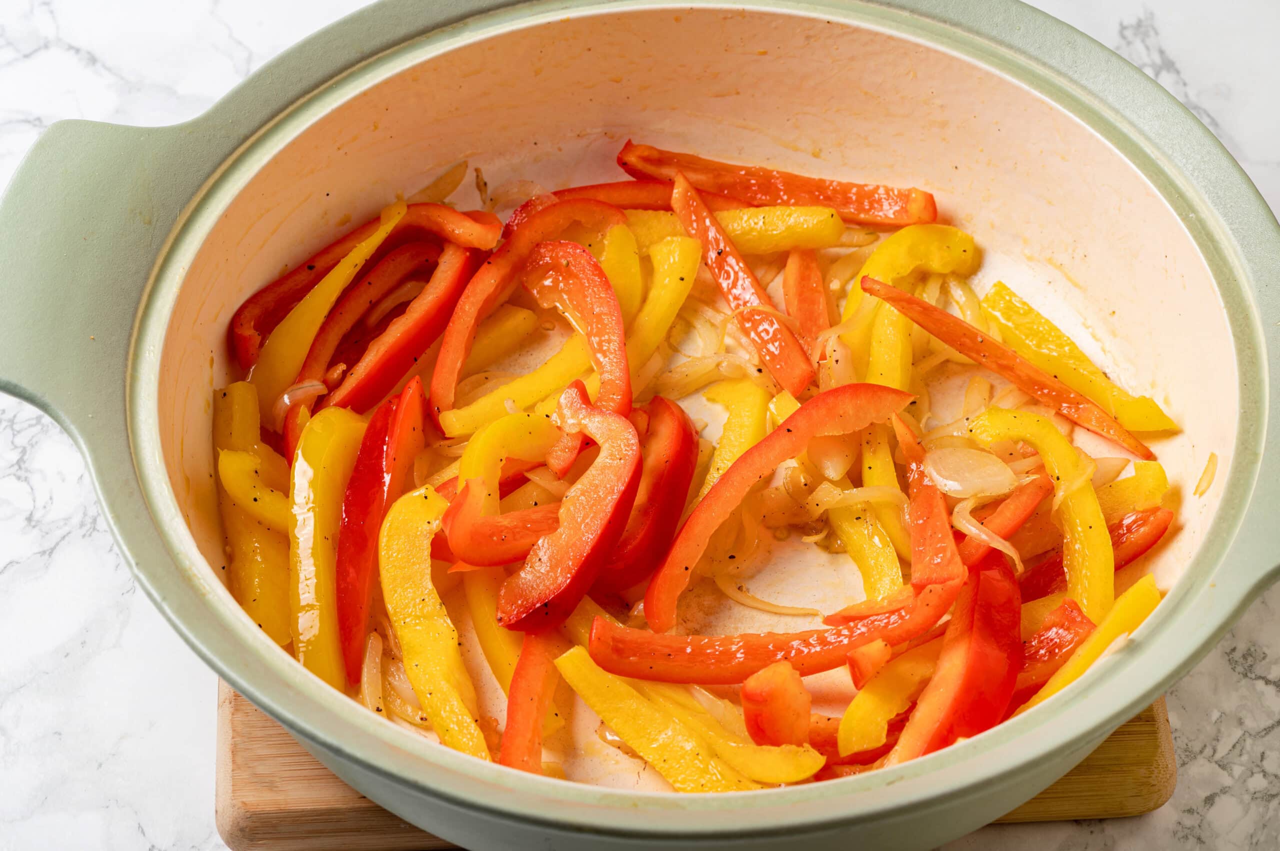 Shrimp Fajitas Sautéing bell peppers and onions in a skillet.
