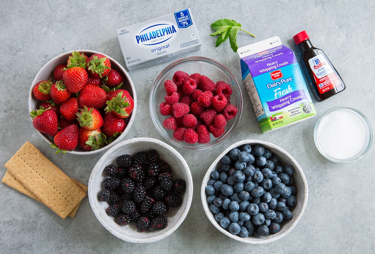 Berry Cheesecake Fruit Salad ingredients strawberries raspberries blackberries blueberries graham crackers cream cheese cream vanilla mint