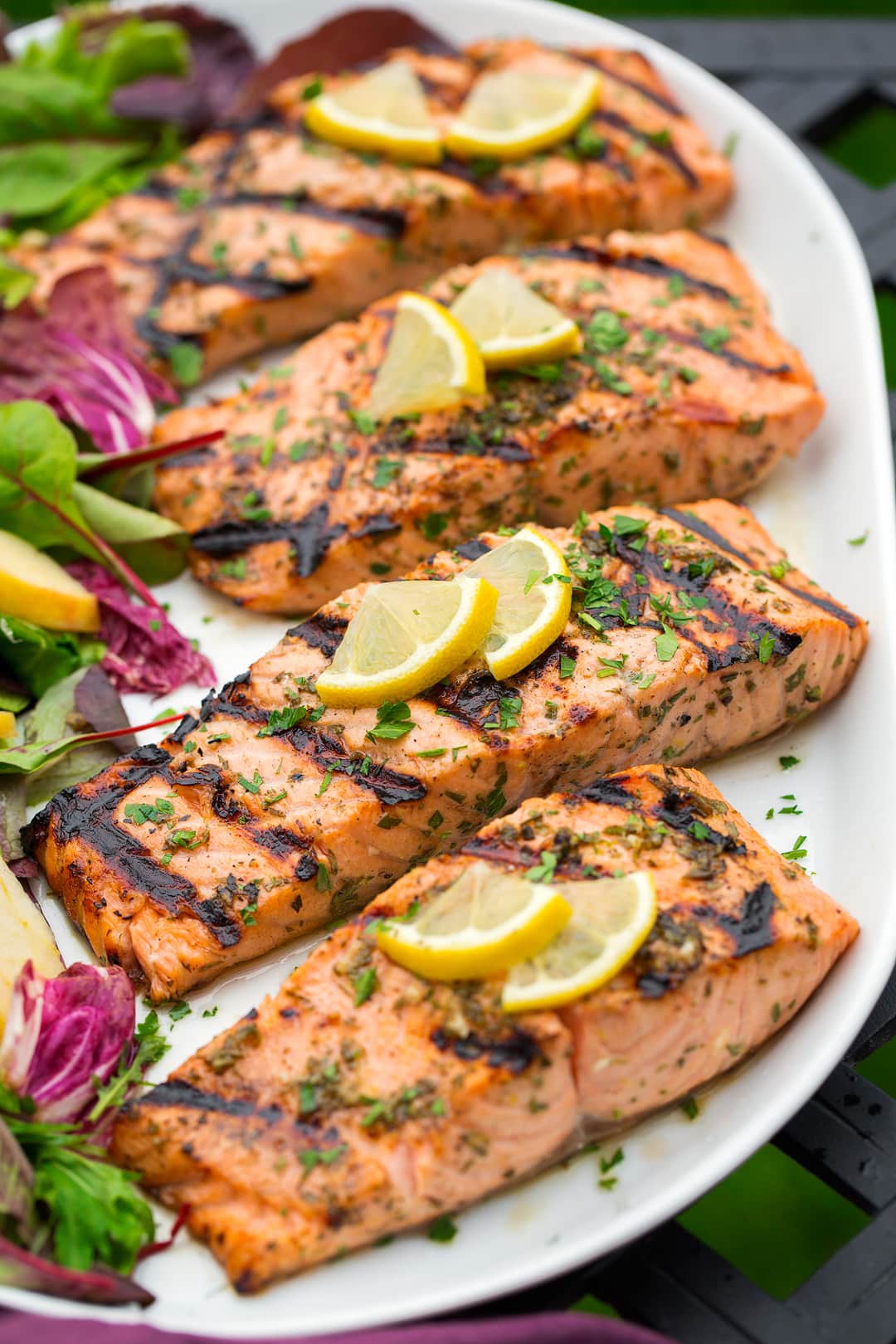 grilled lemon garlic salmon fillets on white platter