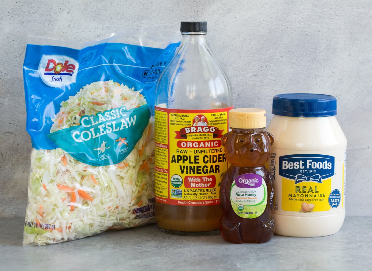 Coleslaw Recipe Coleslaw ingredients show here including mayonnaise, honey, apple cider vinegar, and cabbage coleslaw mix.
