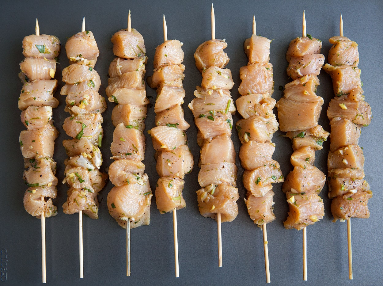honey lime chicken skewers threaded onto skewer before grilling