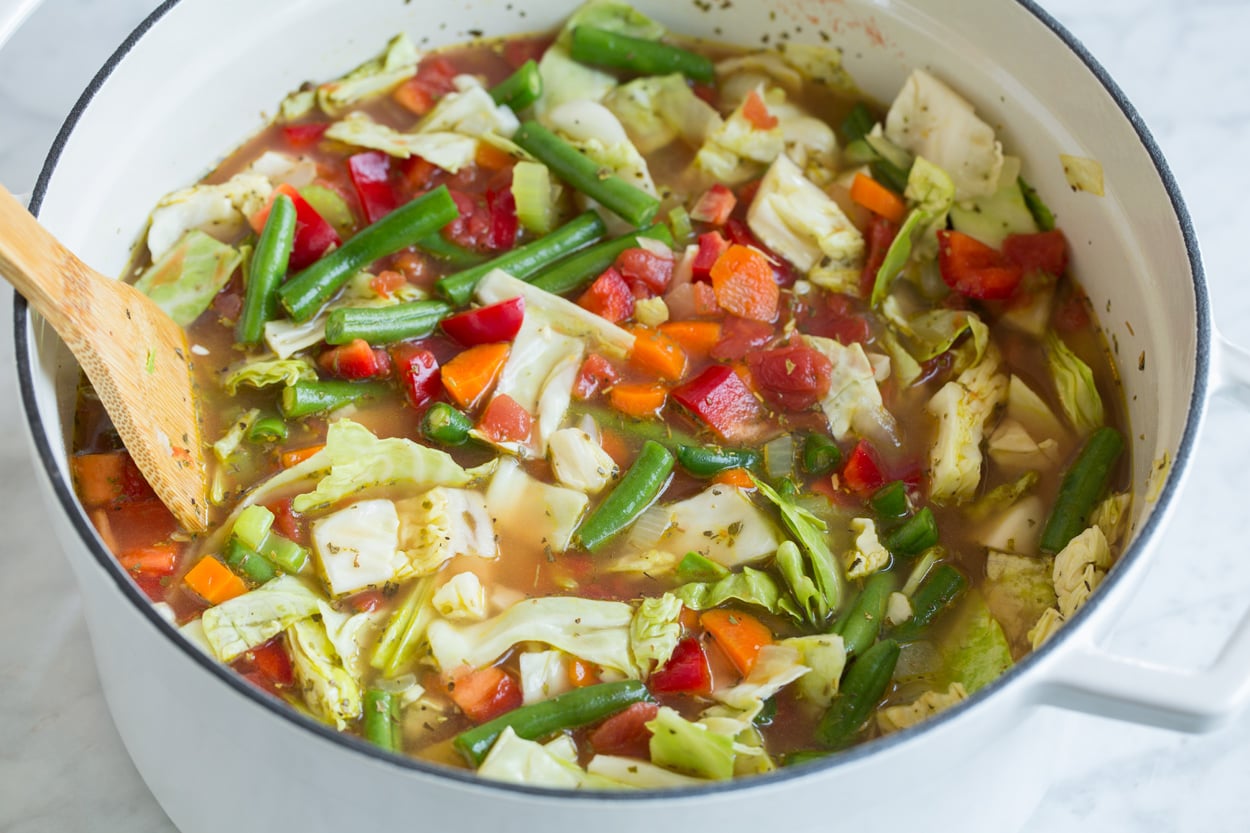Cabbage Soup Cabbage soup cooking in a large pot.