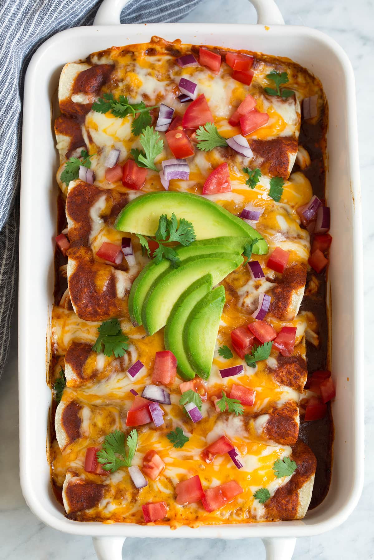 homemade chicken Enchiladas in white baking dish
