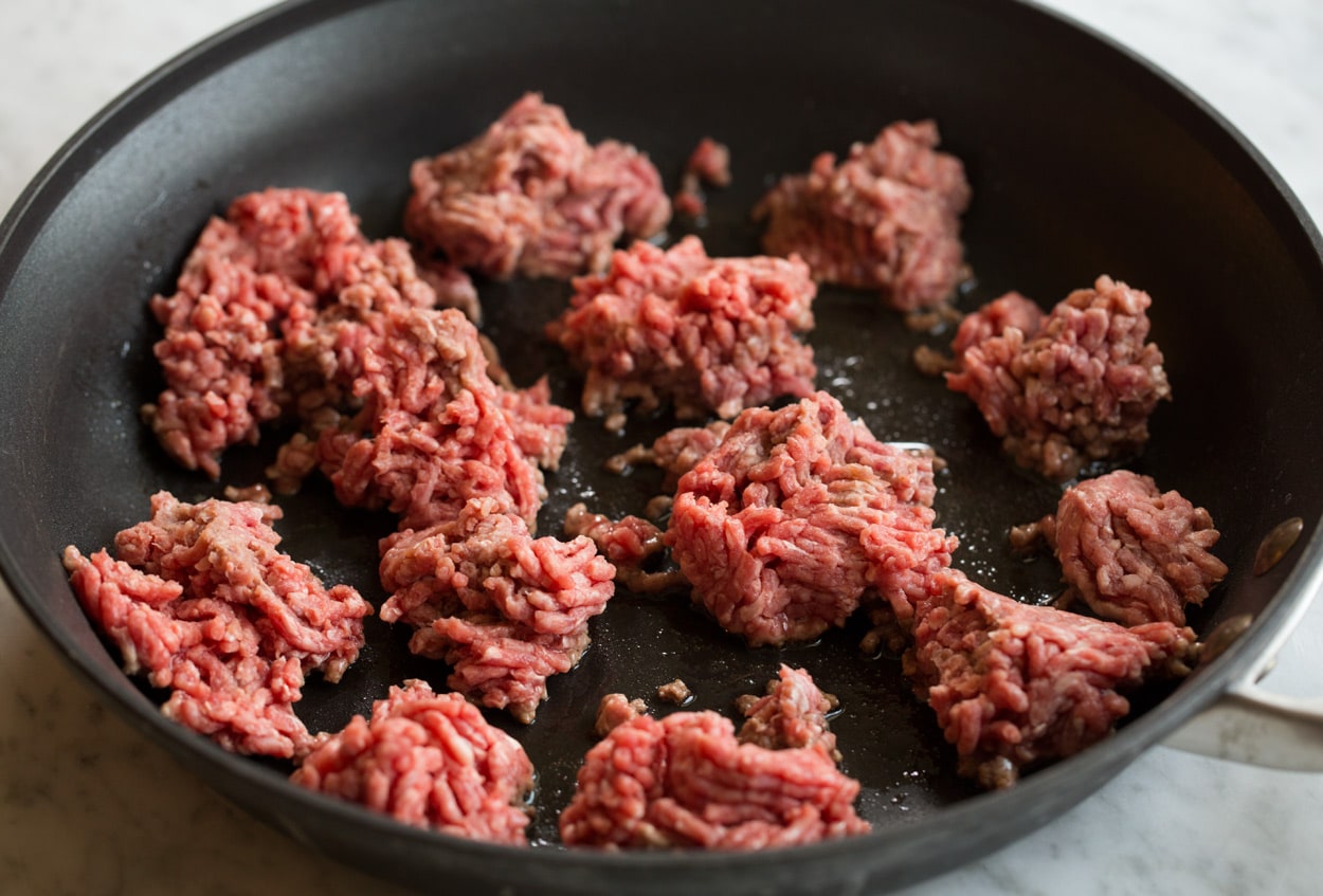 Homemade Spaghetti Sauce Showing how to make spaghetti sauce, browning beef in dark non-stick skillet in portions.
