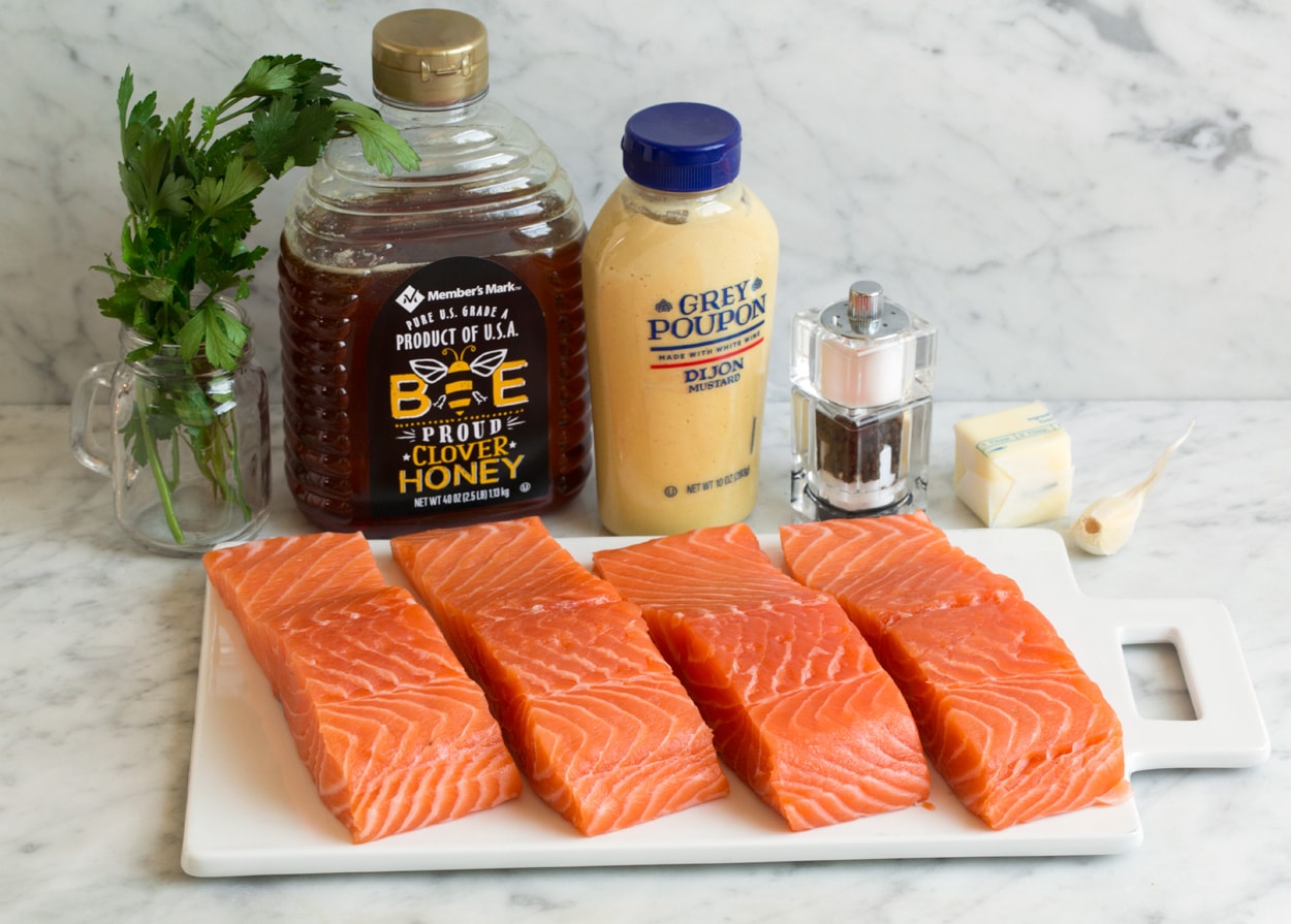 Baked Salmon with Buttery Honey Mustard Sauce Ingredients for baked salmon shown here. Salmon fillets honey dijon mustard garlic salt pepper parsley.