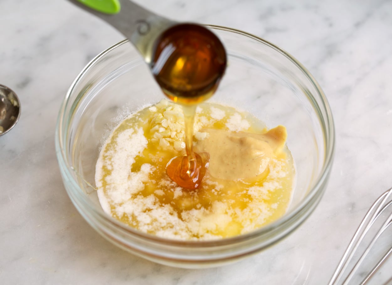 Baked Salmon with Buttery Honey Mustard Sauce Mixing sauce ingredients in a mixing bowl for baked salmon.