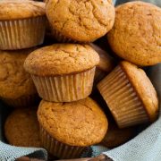 Pumpkin Muffins shown here in a basket lined with light blue burlap fabric