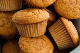 Pumpkin Muffins shown here in a basket lined with light blue burlap fabric