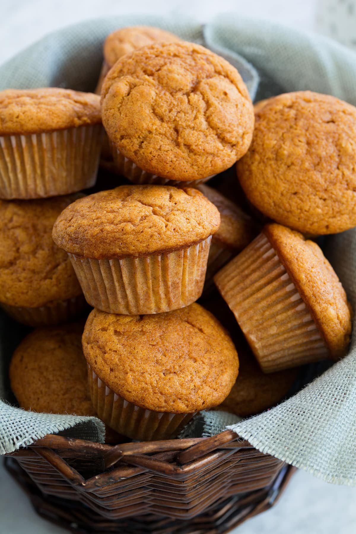 Pumpkin Muffins shown here in a basket lined with light blue burlap fabric