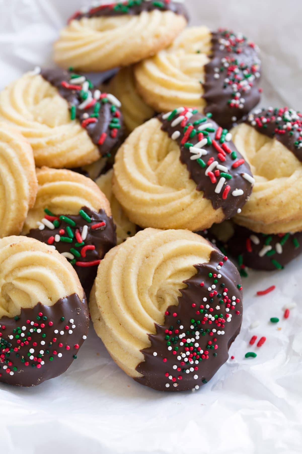Butter Cookies Butter cookies dipped in chocolate and covered with Christmas sprinkles.