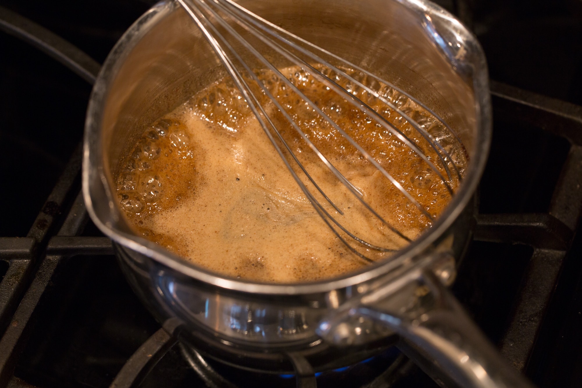Simmering honey mixture in saucepan for granola.