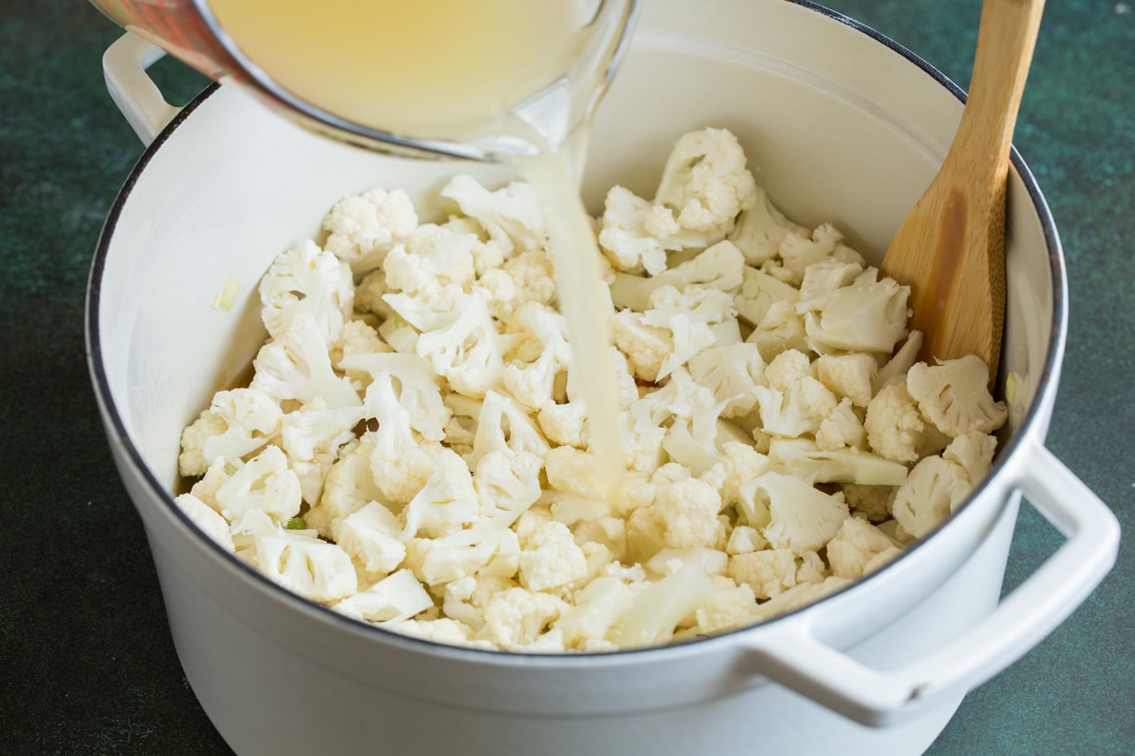 Cauliflower Soup Adding cauliflower and chicken broth to Cauliflower Soup.