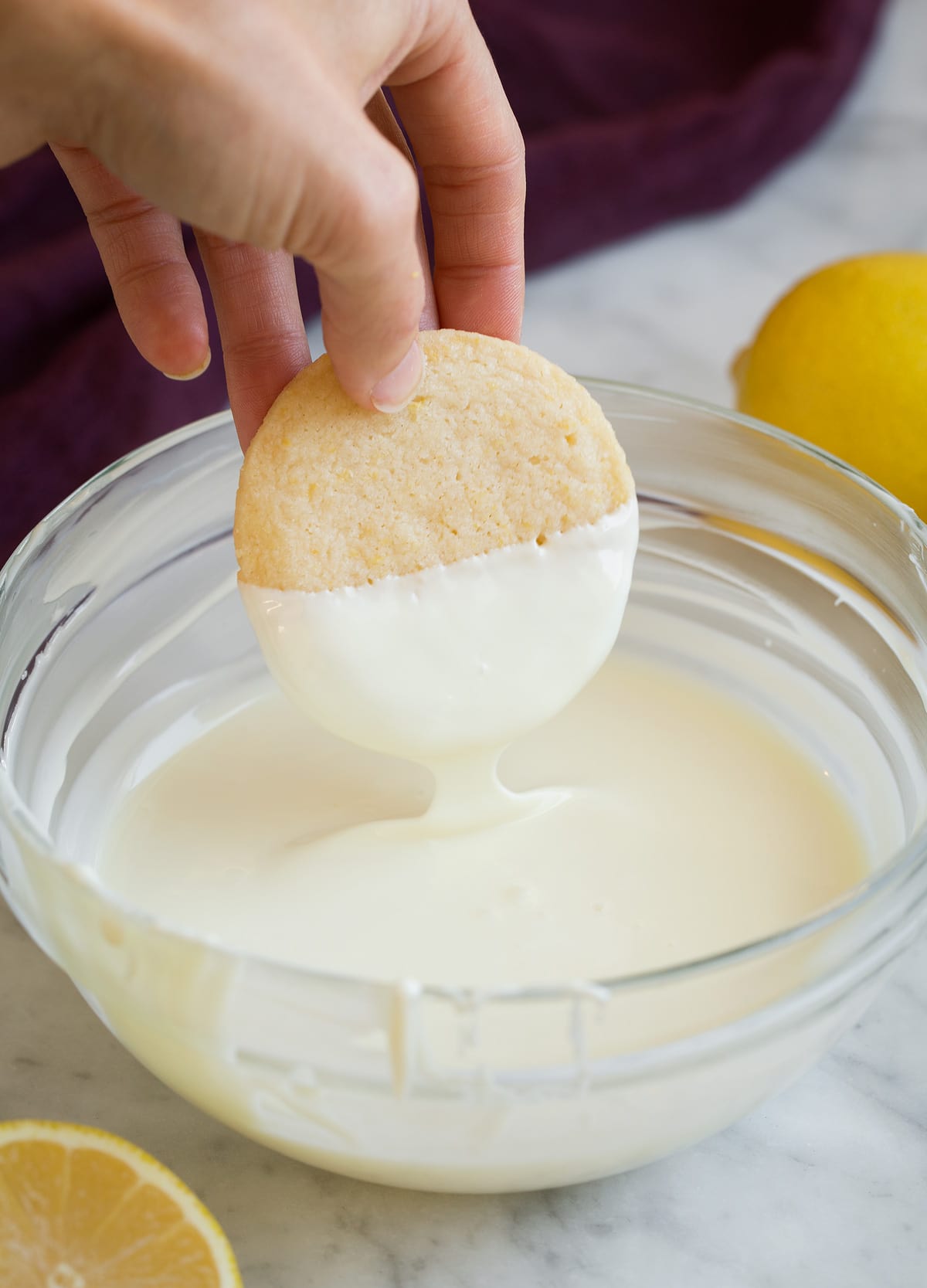 Lemon Shortbread Dipping lemon shortbread cookies in melted white chocolate.