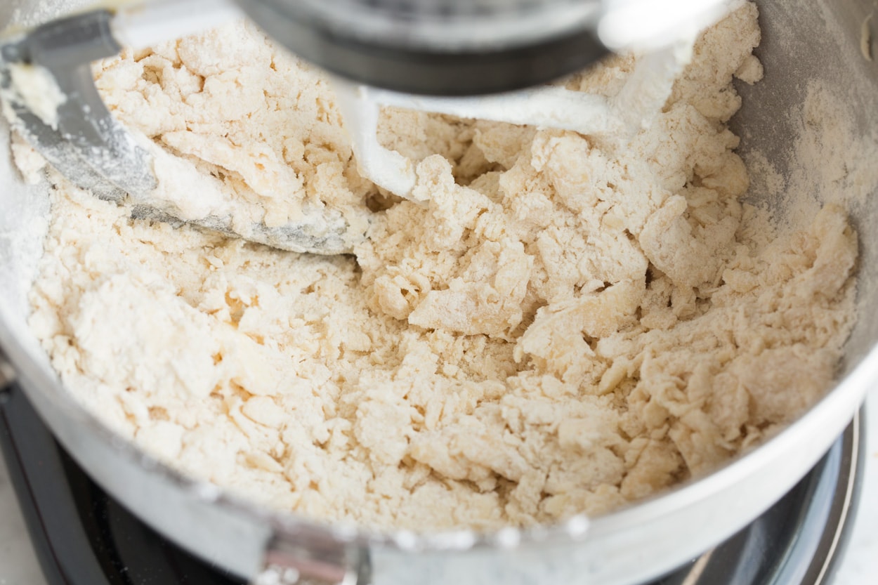 Mexican Wedding Cookies Sandy flour mixture coming together in mixing bowl. For Mexican Wedding Cookies.