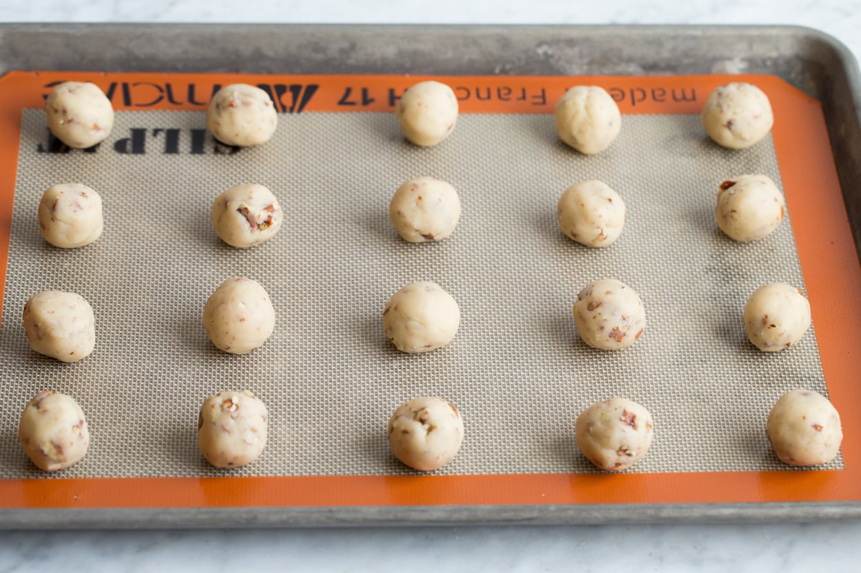 Mexican Wedding Cookies Shaped rounds of Mexican wedding cookie dough balls on baking sheet before baking.