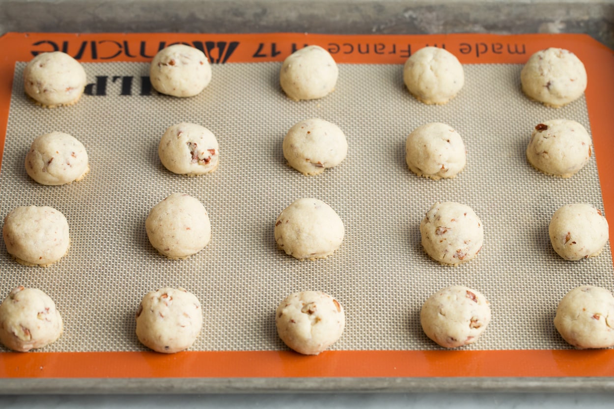 Mexican Wedding Cookies Twenty Mexican Wedding Cookies after baking on baking sheet.