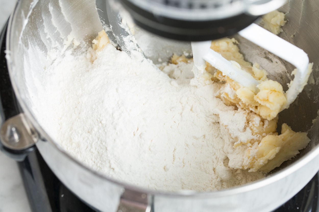 Mexican Wedding Cookies Mixing flour into Mexican Wedding Cookie dough.