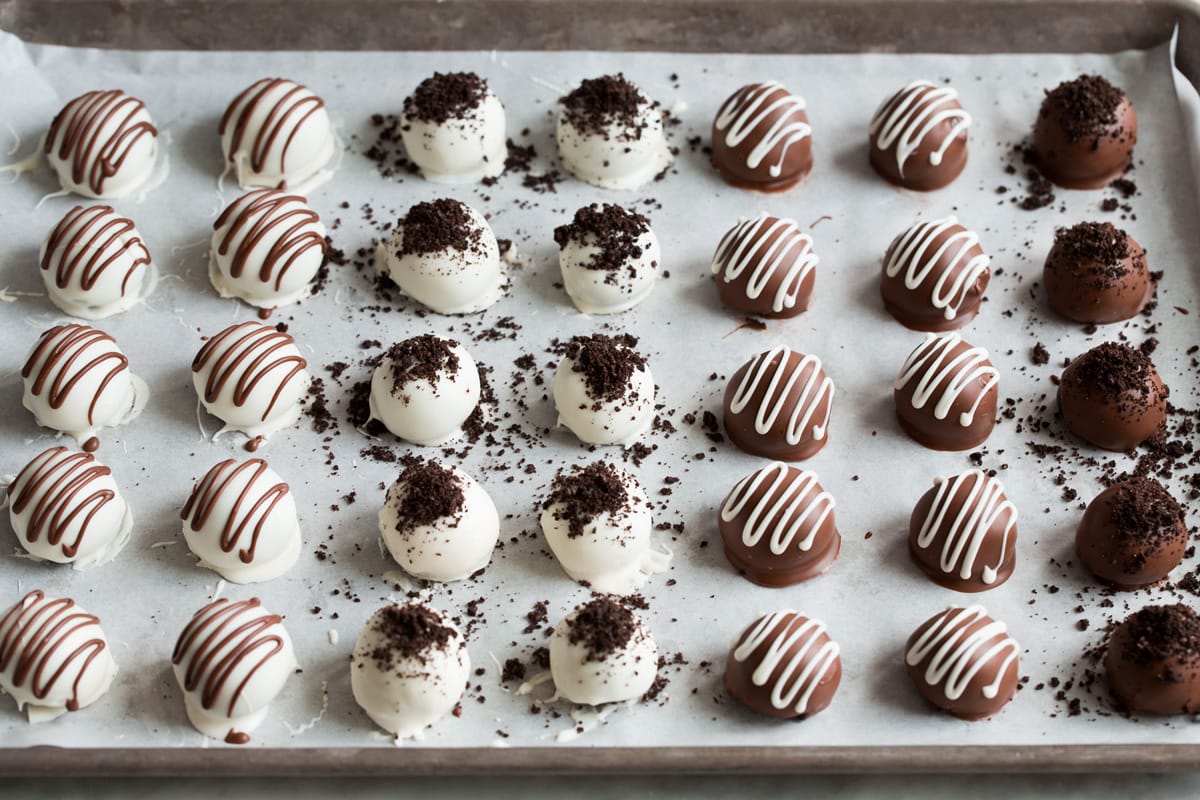 Oreo Balls Oreo Truffles Rows of finished Oreo balls on a parchment paper lined baking sheet.