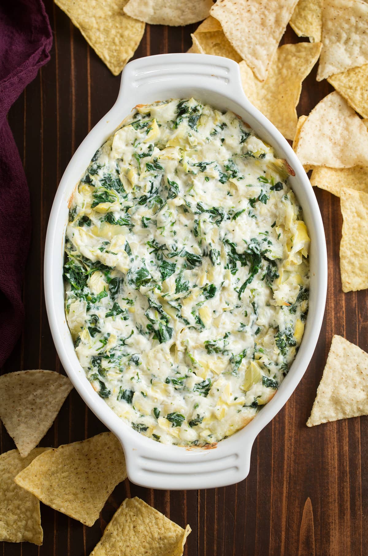 Spinach Artichoke Dip Spinach Artichoke Dip in a small white baking dish.