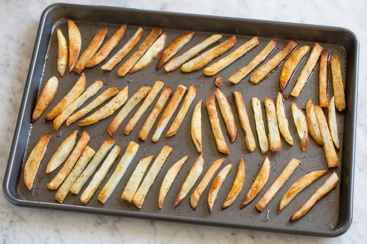 Baked French Fries French fries after baking in the oven on a baking sheet.